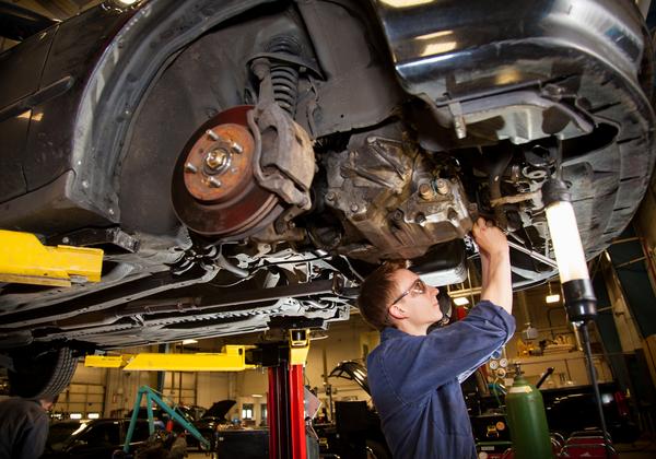 Student working under car