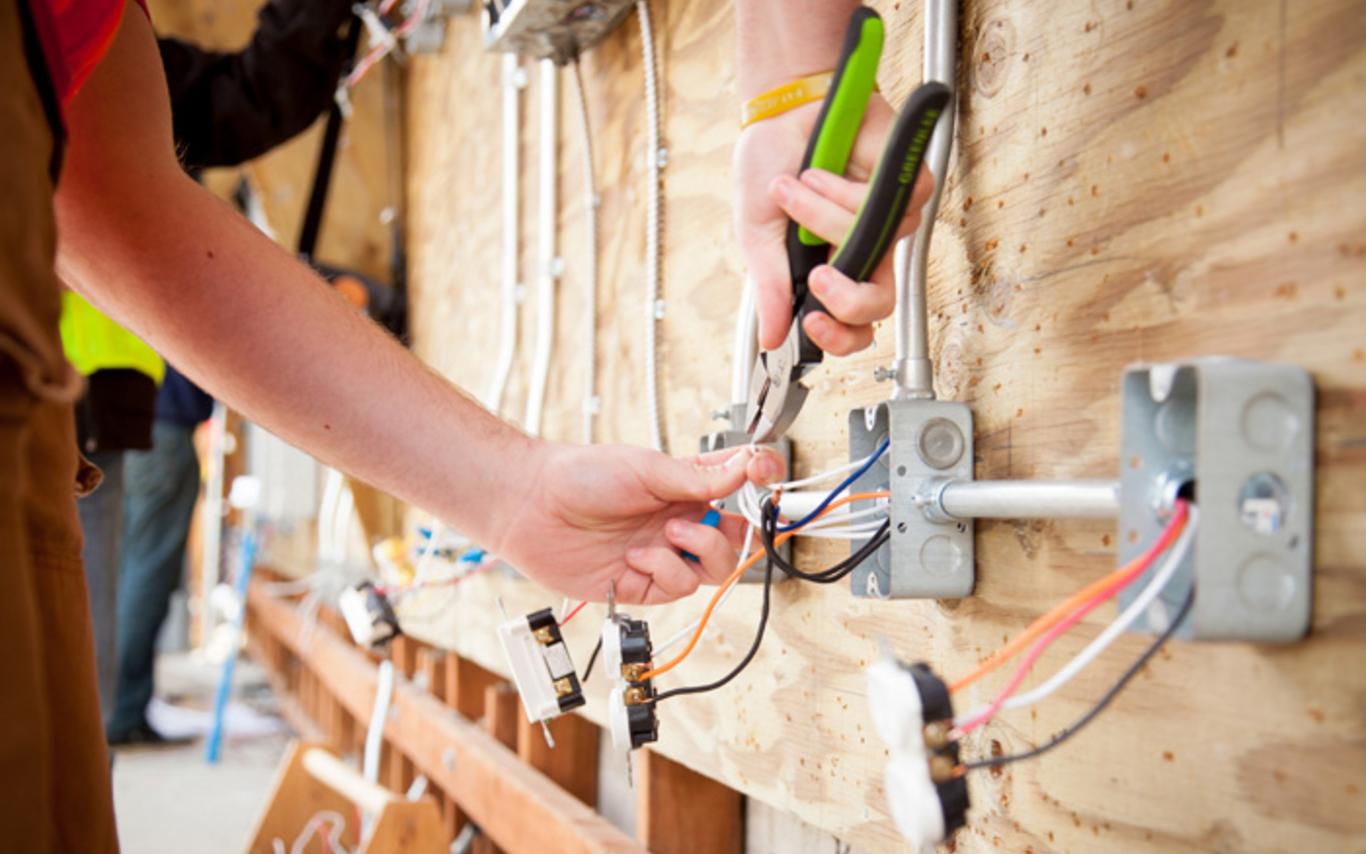 Student using pliers on wiring