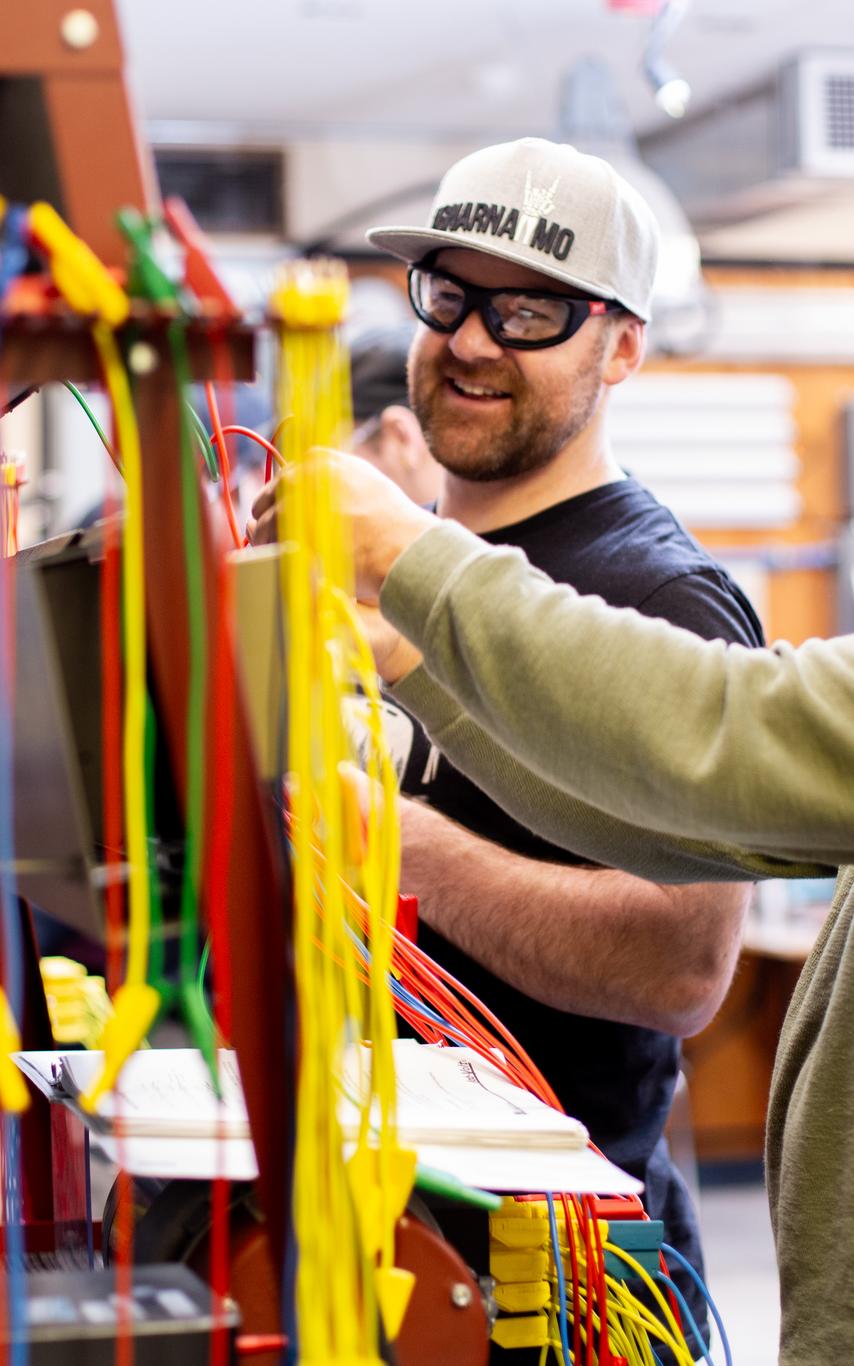 To VIU electrical students work together in class